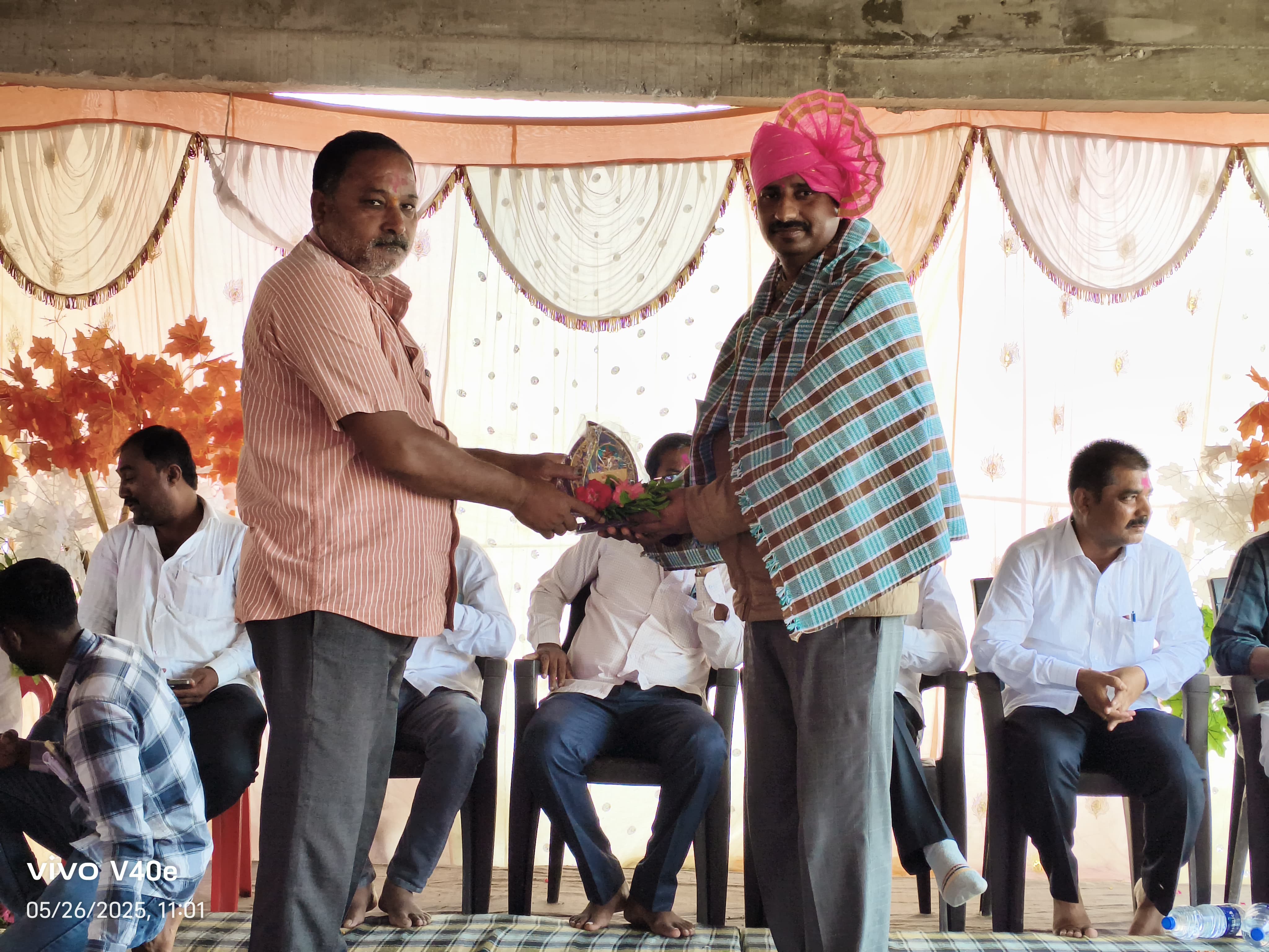 Community ceremony with traditional turban and gift exchange