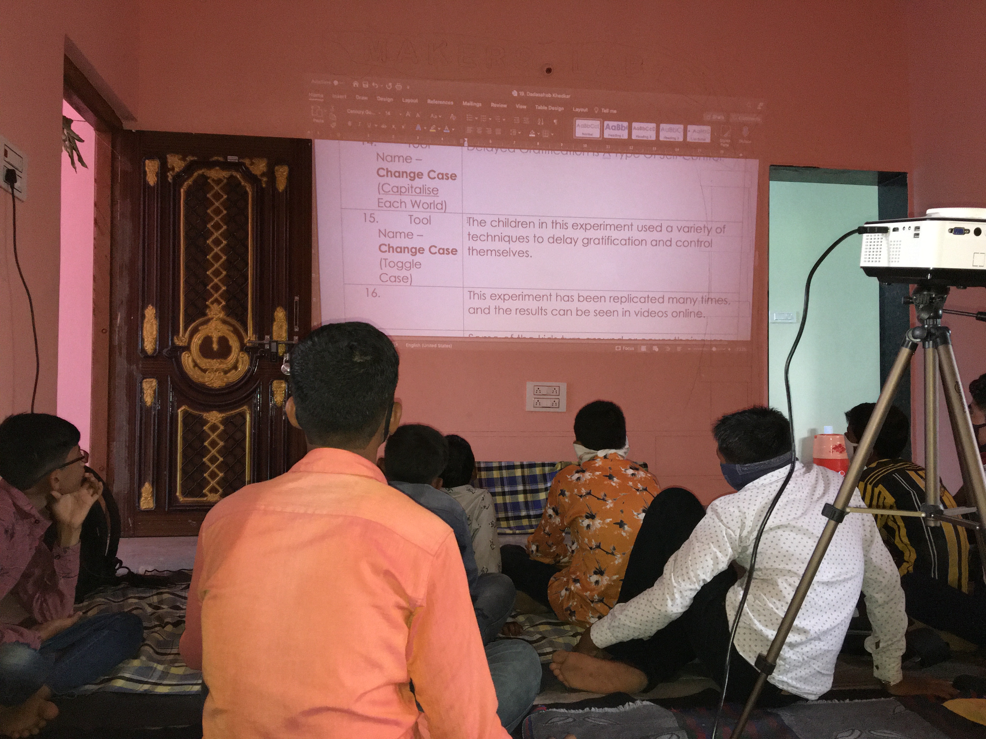 Community members watching educational presentation