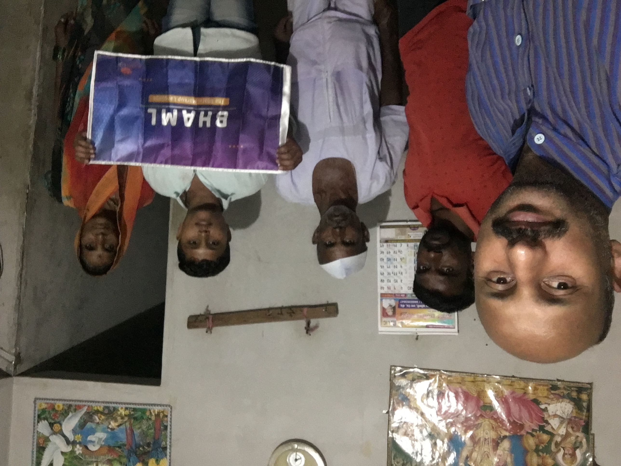 BHAML team visiting local family with banner