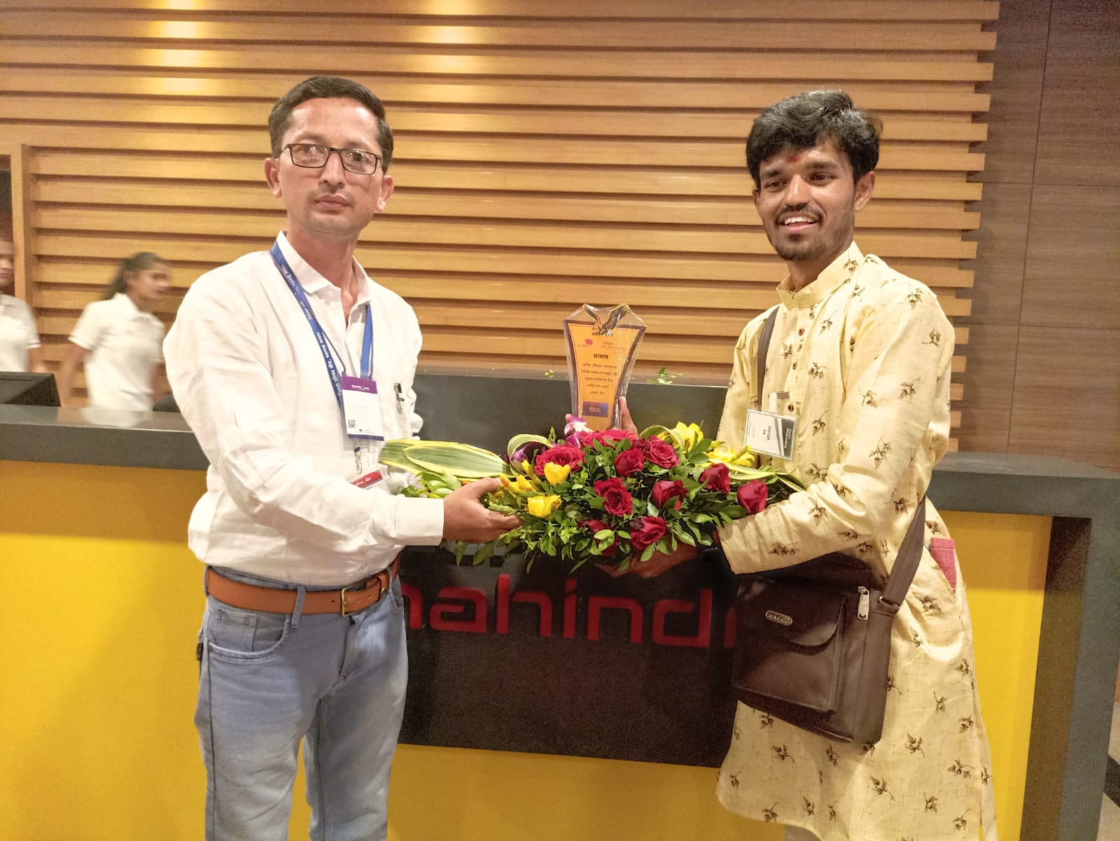 Award ceremony at Mahindra office with flower exchange