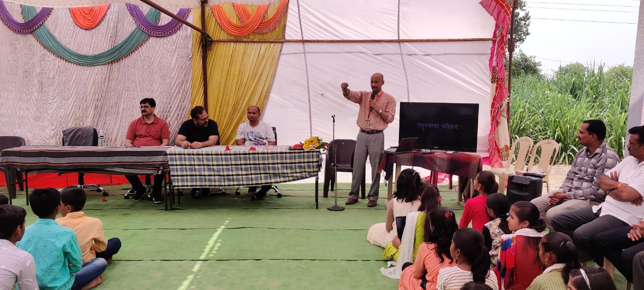 Indoor workshop with instructor and students under tent