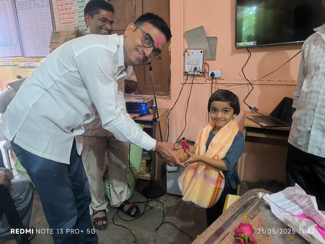 Young student receiving recognition from official